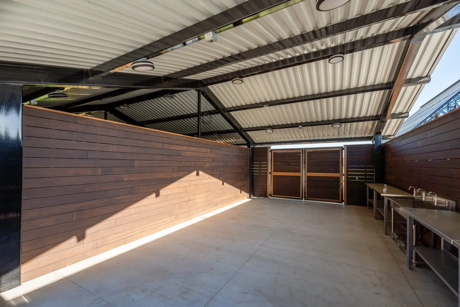 Shade structure interior with wood cladding