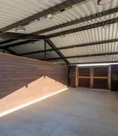 Shade structure interior with wood cladding